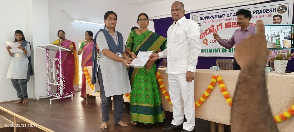 Student receiving appointment letter on stage