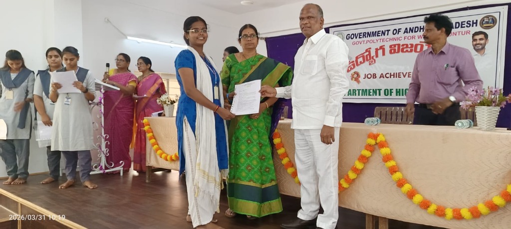 Student receiving appointment letter on stage